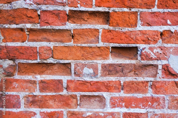 Fototapeta The texture of the old destroyed red brick wall. An ancient building.