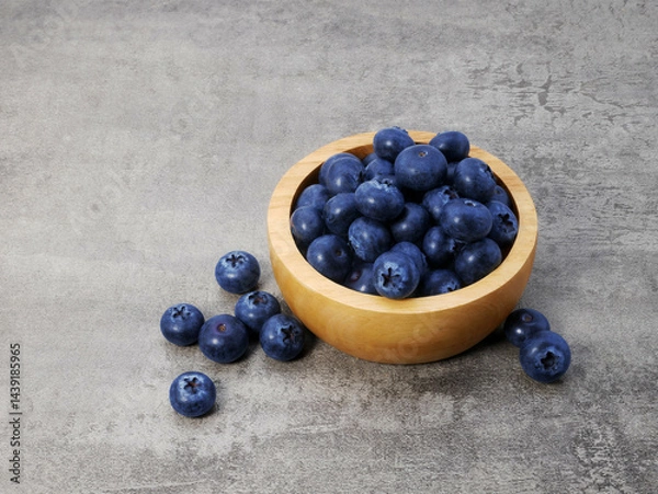 Obraz Blueberries in wooden bowl on stone texture background