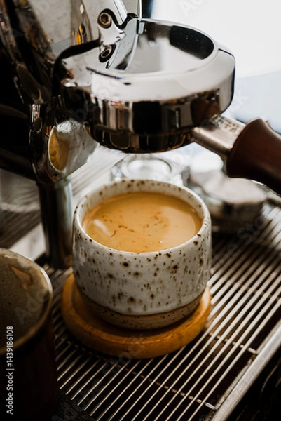 Obraz Espresso pouring from coffee machine at cafe,Brewing the espresso coffee from the machine warm tone