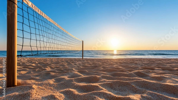 Fototapeta Tranquil beach scene featuring silhouetted volleyball net against stunning sunset. soft sand