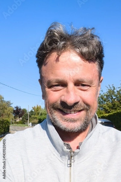 Fototapeta smiling handsome middle aged man cheerful guy making selfie photo in summer day