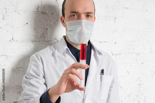 Fototapeta Doctor holds in a hand syringe inside the injection of vitamin