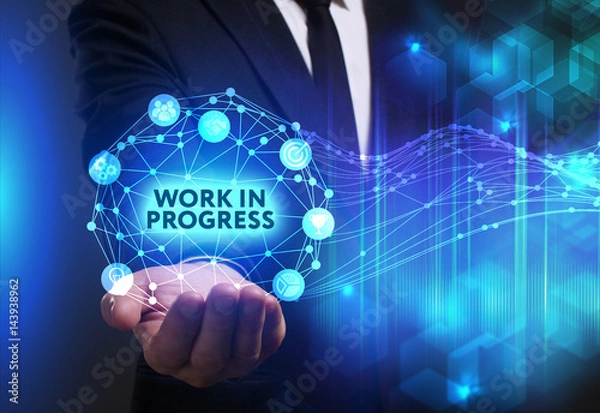 Fototapeta Business, Technology, Internet and network concept. Young businessman working on a virtual screen of the future and sees the inscription: Work in progress