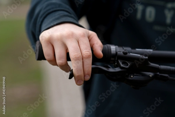 Obraz Child's hand mistakenly pressing on a bicycle handbrake lever