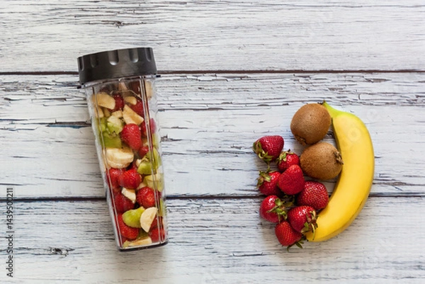 Fototapeta Fresh fruits and smoothie ingredients on rustic table