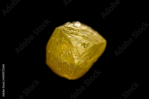 Fototapeta Closeup natural rough uncut fancy yellow diamond crystal on dark background (selective focus)