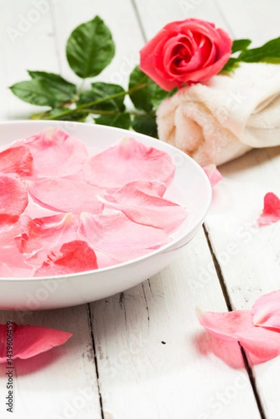 Obraz Spa concept with pink rose, rose petals in bowl of water and rolled towel on white wooden background