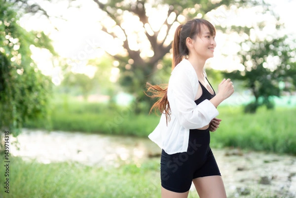 Obraz Portrait of beautiful asian Young woman in white robe wearing sportswear jogging working out outside. training on public equipment in outdoor at park. concept Exercise Healthy lifestyle.