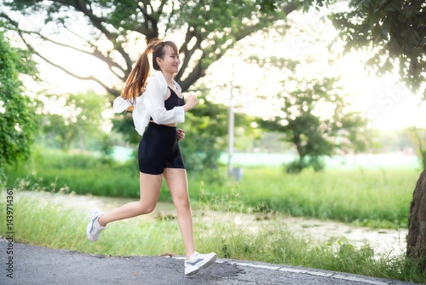 Obraz Portrait of beautiful asian Young woman in white robe wearing sportswear jogging working out outside. training on public equipment in outdoor at park. concept Exercise Healthy lifestyle.