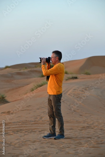 Fototapeta Tourist in Dunes of Rub Al Khali desert. Wahiba Sands. Sultanate of Oman.