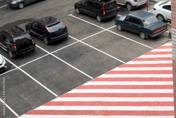 Obraz Parking in front of a residential building with a place for emergency stopping.