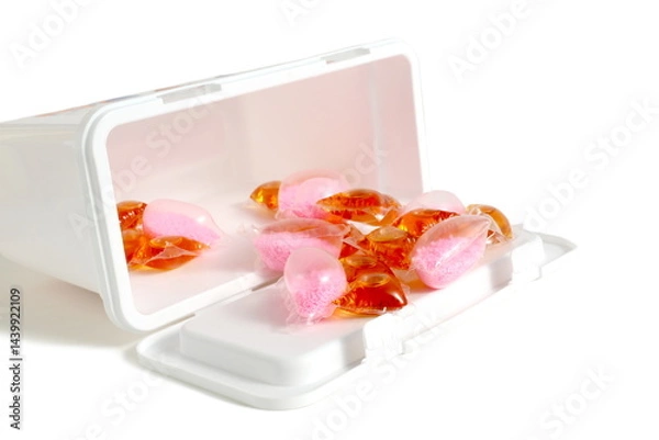 Obraz  On a white background there are washing capsules with packaging.