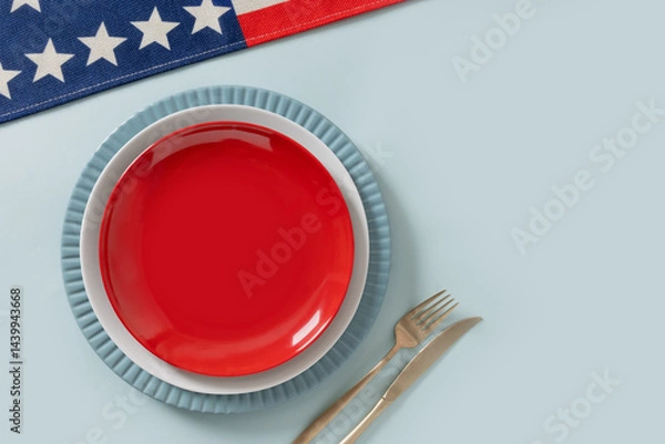 Obraz American table setting for USA Independence Day. Festive dinner with empty white plate and decoration in USA national flag colors red and blue. View from above. Copy space.