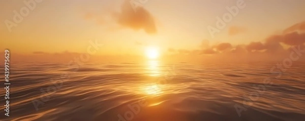 Fototapeta A serene ocean view with a bright sun shining through clouds during a golden sunset over calm waters