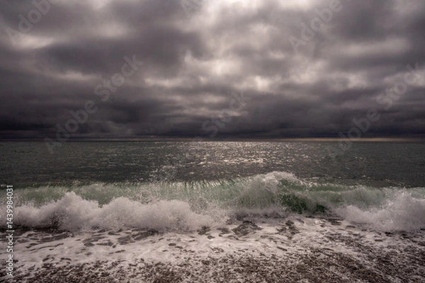 Fototapeta Dark storm clouds over ocean. Dramatic seascape. Clouds and rain flurry over sea.