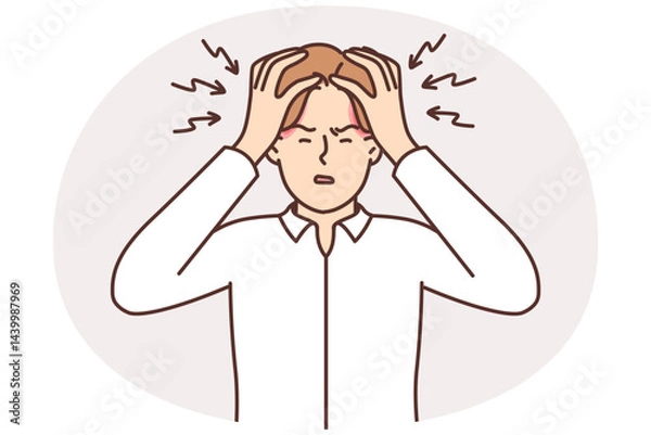 Fototapeta Tormented man clutches head and squints due to overworking and large number of work tasks