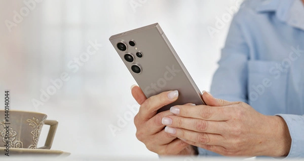 Fototapeta Close-up of woman's hands scrolling browsing websites and shopping online in the cozy comfort of her home. Modern technology and convenience of online shopping.