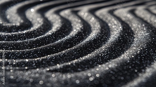 Fototapeta Black sand ripples creating a peaceful pattern.