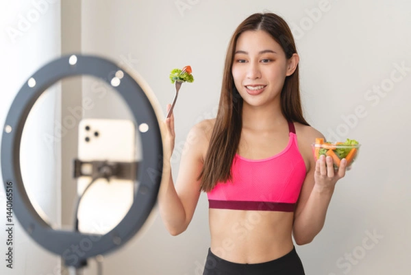 Fototapeta Asia healthy beautiful blogger influencer showing plant-based protein whey product on her live streaming channel to viral marketing brand online in wellness group follower.