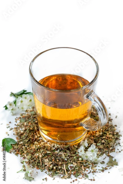 Fototapeta Herbal tea served in a glass cup with dried herbs