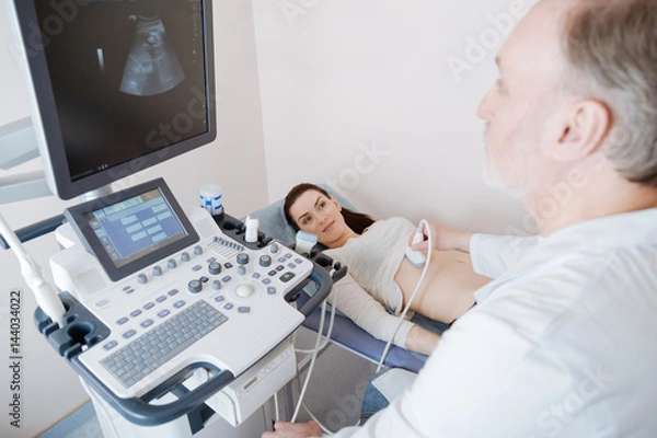 Fototapeta Attentive prominent specialist disclosing a diagnosis