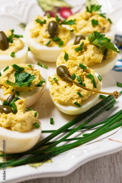 Fototapeta Eggs stuffed with mousse of egg yolk, mayonnaise, mustard and capers.