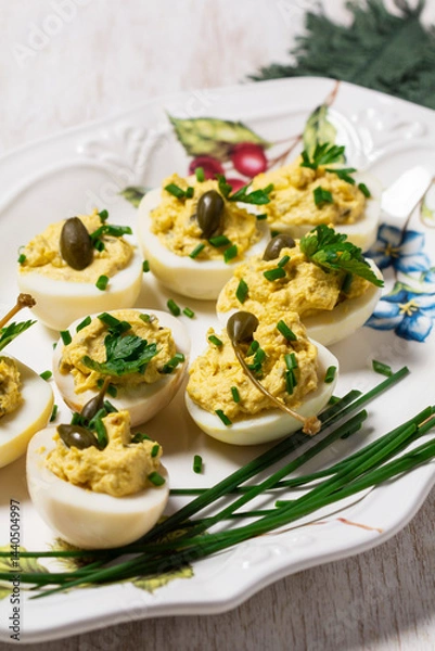 Fototapeta Eggs stuffed with mousse of egg yolk, mayonnaise, mustard and capers.