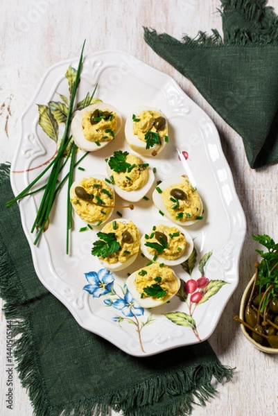 Fototapeta Eggs stuffed with mousse of egg yolk, mayonnaise, mustard and capers.