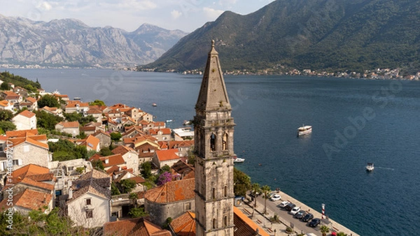 Fototapeta Aerial view of bell tower in Perast city in Kotor Bay, Montenegro. Cityscape of the country tourist attraction in summer travel