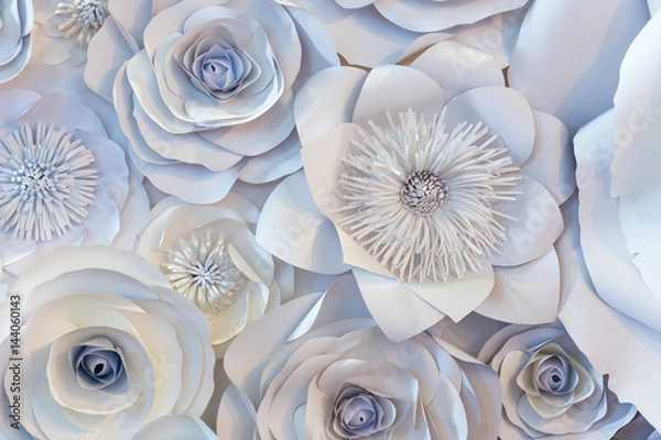Fototapeta Wall with a background of paper flowers handmade.