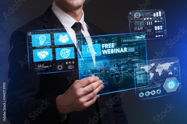 Fototapeta Business, Technology, Internet and network concept. Young businessman working on a virtual screen of the future and sees the inscription: Free webinar