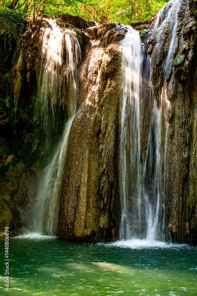 Obraz Hidden waterfall cascading through lush green forest in a serene natural oasis