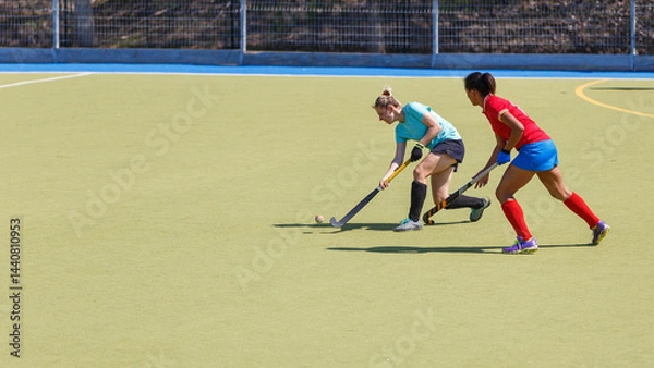 Fototapeta Two field hockey players fighting for the ball during the match