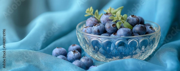 Obraz Fresh blueberries in a bowl on turquoise fabric background  