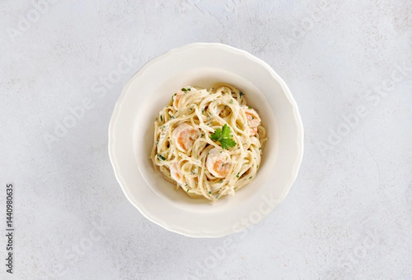 Obraz Spaghetti with shrimps, parsley and cream sauce on a white background. Top view. Italian food.