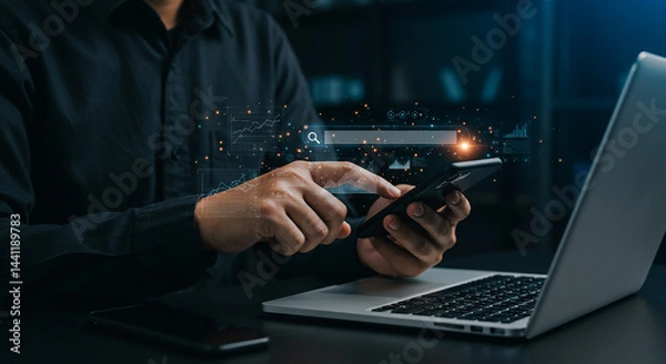 Fototapeta Entrepreneurship, startup, corporate man using a smartphone with a laptop and search bar graphic overlay in a modern office setting
