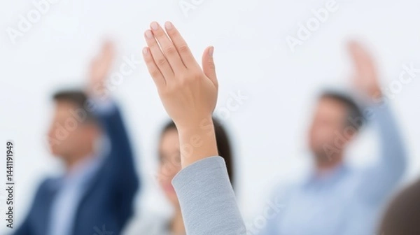 Fototapeta Participants engage in a meeting to express opinions by raising hands during a discussion in a modern office setting.