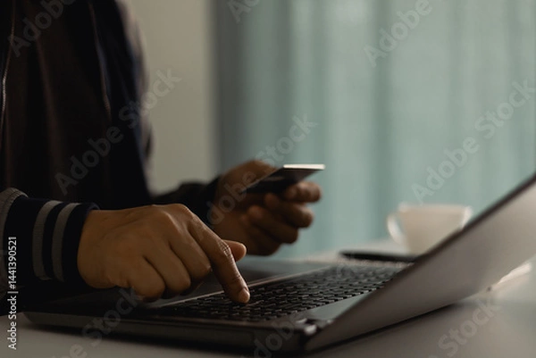 Fototapeta Customer is hand paying for service subscription with credit card on laptop at home office. Subscription business model concept. Follow the subscription membership monthly plan package on social media