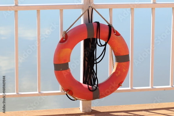 Fototapeta Safety swim ring at the fence of river shore and sea shore. Standard security for tourism. 