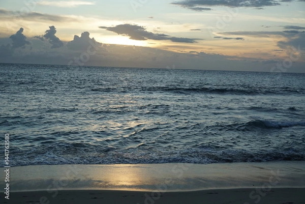 Fototapeta Sunset serenity over ocean waves tropical beach nature photography calm atmosphere wide angle tranquility and beauty