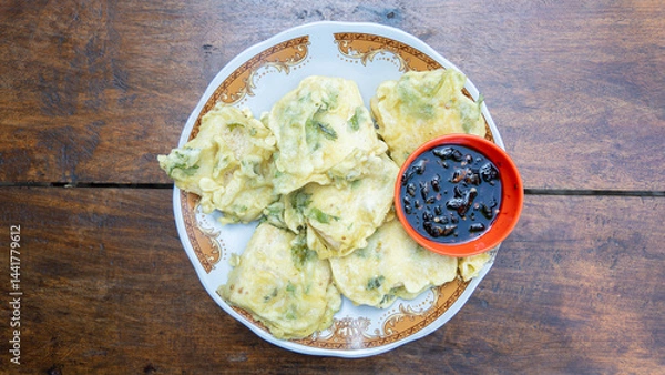 Obraz Gorengan fried tofu on white plate served with spicy soy sauce is traditional authentic typical snack from Java.