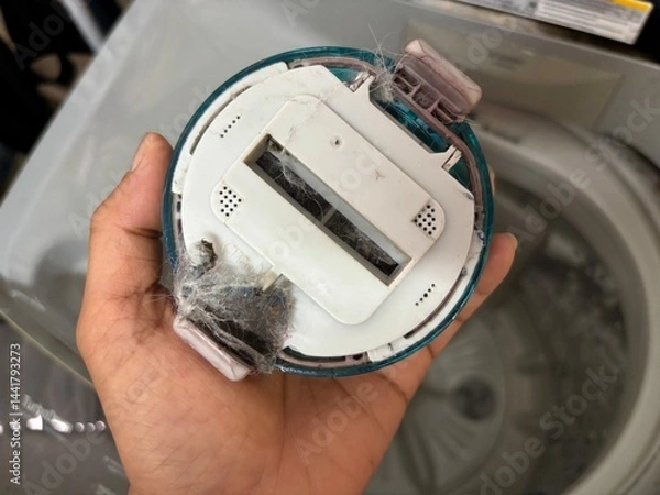 Fototapeta The debris filter cartridge of the washing machine is dirty and full of dog hair.