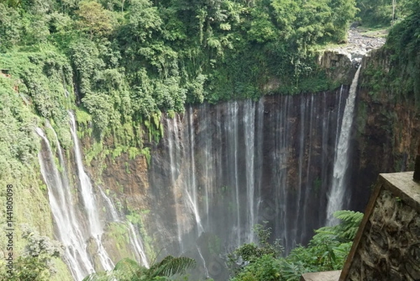 Fototapeta Majestic waterfall adventure in nature's oasis indonesia landscape photography lush green environment aerial view serenity