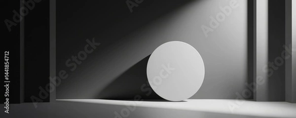 Fototapeta Minimalist design featuring a round object under soft lighting in a dark space.
