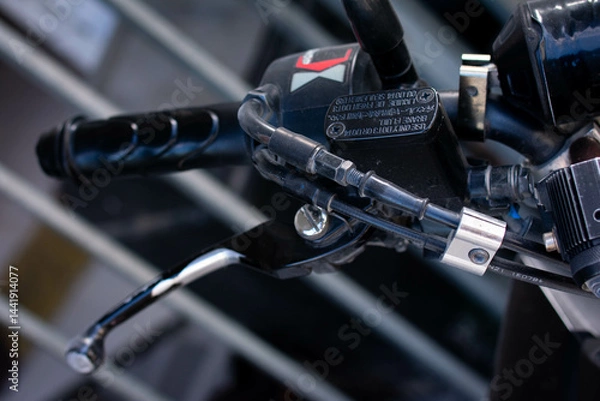 Fototapeta Close up of a motorcycle brake handlebar with detailed grip texture and lever, commonly used for braking control and riding safety