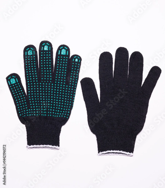 Fototapeta Pair of black work gloves with green rubber grip dots, front and back view on white background