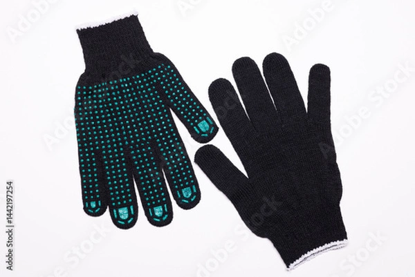 Fototapeta Pair of black work gloves with green rubber grip dots, front and back view on white background