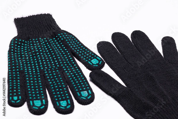 Fototapeta Pair of black work gloves with green rubber grip dots, front and back view on white background