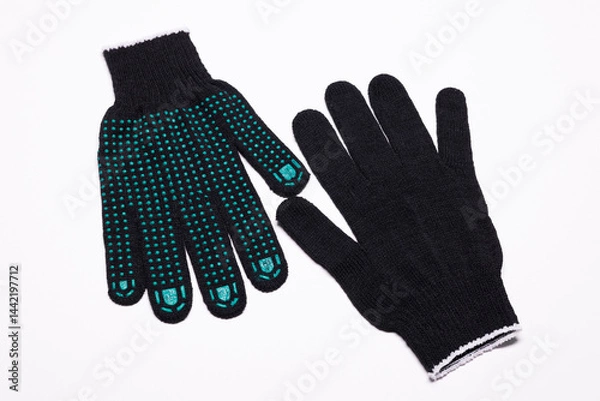 Fototapeta Pair of black work gloves with green rubber grip dots, front and back view on white background