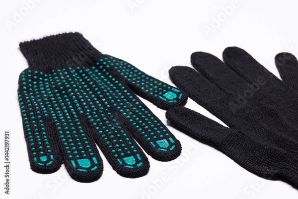 Fototapeta Pair of black work gloves with green rubber grip dots, front and back view on white background